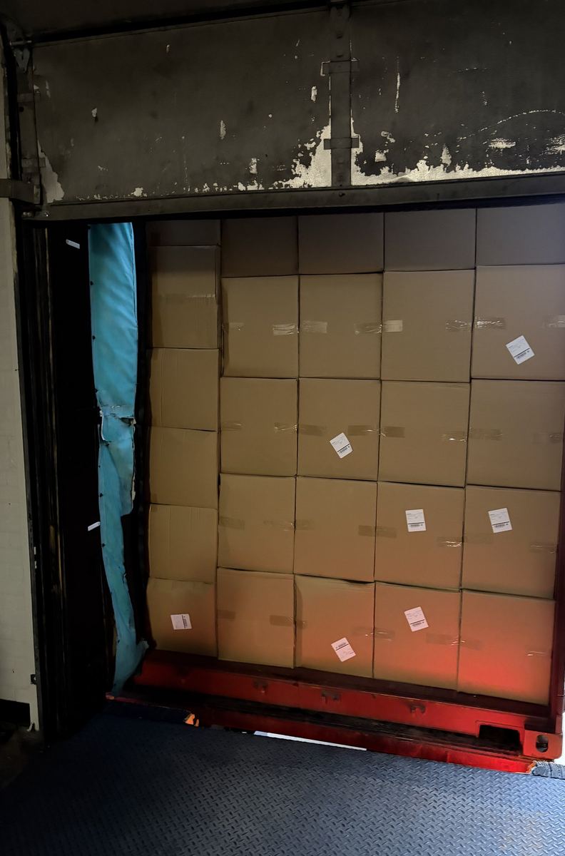 Open container full of floor-loaded cartons